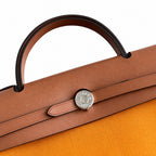 Polished Canvas-and-Leather Handbag: Herbag 31cm Saddle-Inspired Canvas Body with Leather Handle and Shoulder Strap