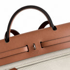 Canvas Body and Leather Trim Design: Herbag 31cm Saddle-Inspired Canvas Body with Leather Handle and Shoulder Strap