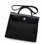 Refined Saddle-Inspired Carry Design: Herbag 31cm Saddle-Inspired Canvas Body with Leather Handle and Shoulder Strap