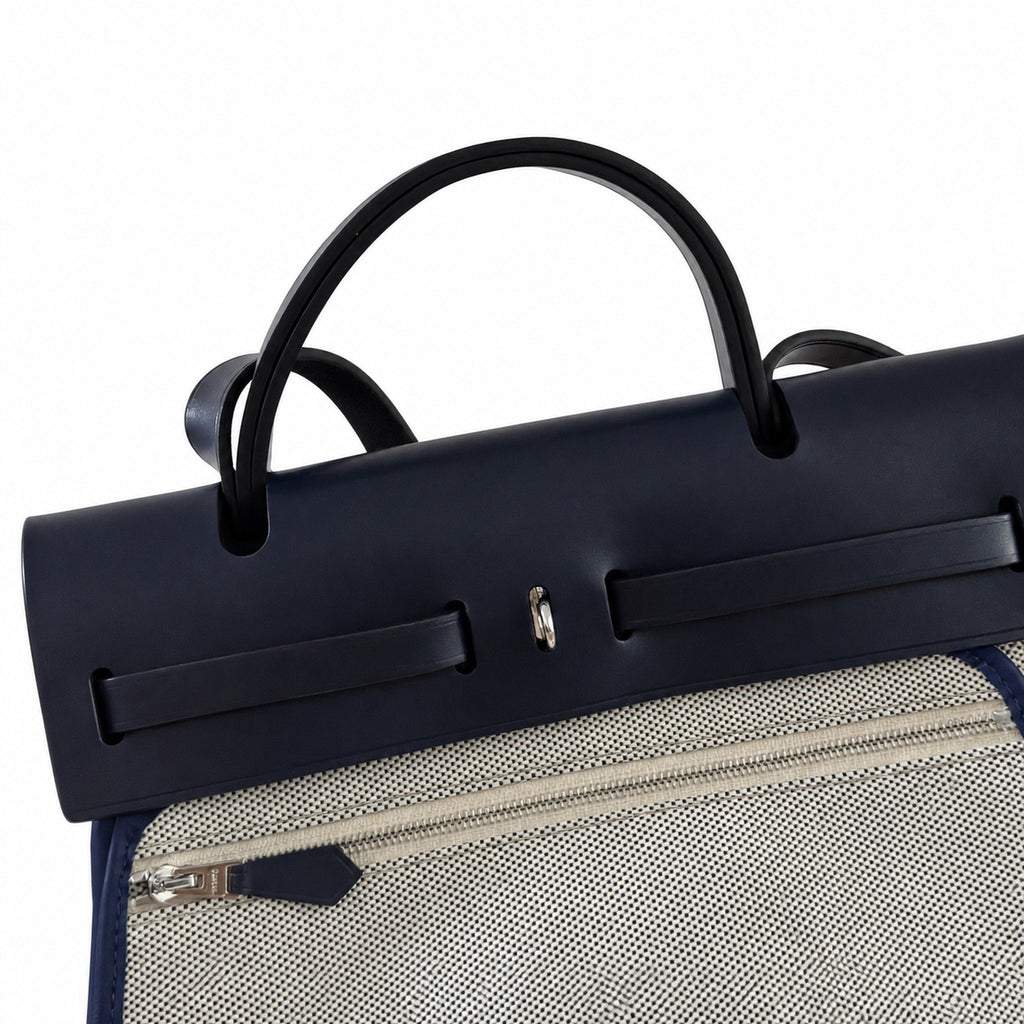 Distinctive Leather-Trimmed Canvas Design: Herbag 31cm Saddle-Inspired Canvas Body with Leather Handle and Shoulder Strap