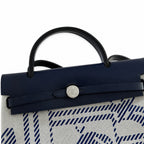 Distinctive Leather-Trimmed Canvas Design: Herbag 31cm Saddle-Inspired Canvas Body with Leather Handle and Shoulder Strap