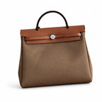 Herbag 31cm Saddle-Inspired Canvas Body with Leather Handle and Shoulder Strap — Structured Leather-Trimmed Canvas Carryall
